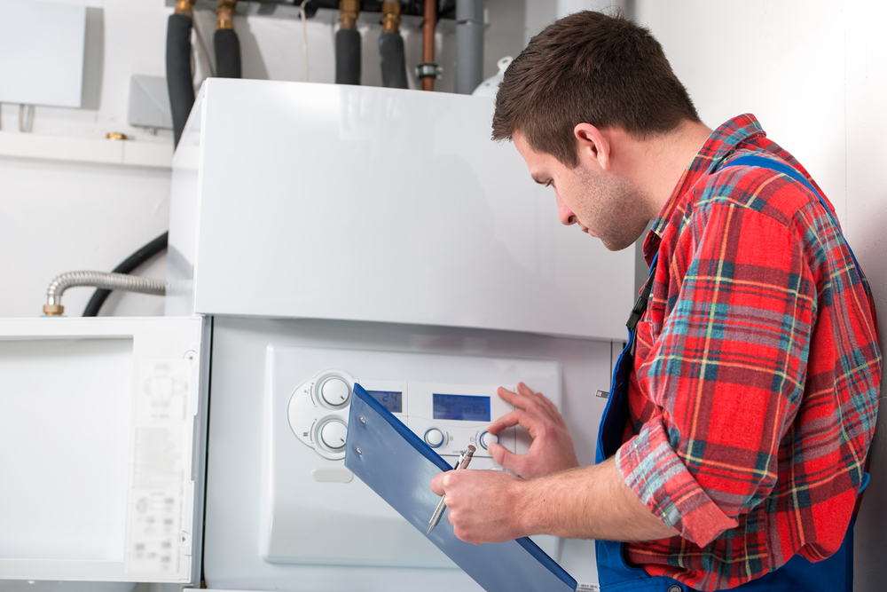 HVAC heating repair professional inspecting a home heater system for service. 