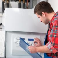 HVAC heating repair professional inspecting a home heater system for service. 