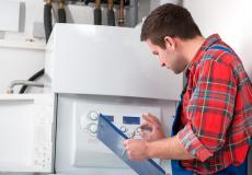 HVAC heating repair professional inspecting a home heater system for service. 